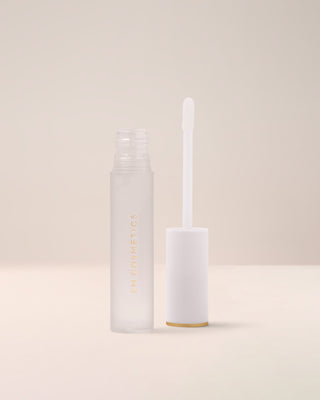 EM Cosmetics Morning Dew Crystal Lip Gloss in Quartz, a clear gloss, shown open with its applicator for a glassy finish.