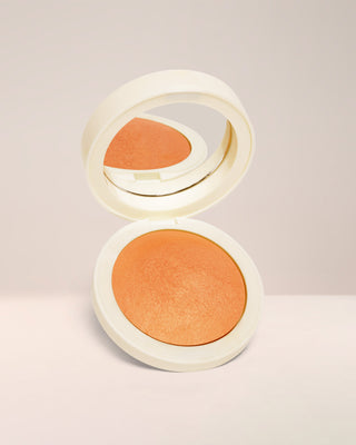 Open compact of EM Cosmetics Heaven's Glow Radiant Veil Blush in Heirloom Persimmon, showing the marbled, baked texture.