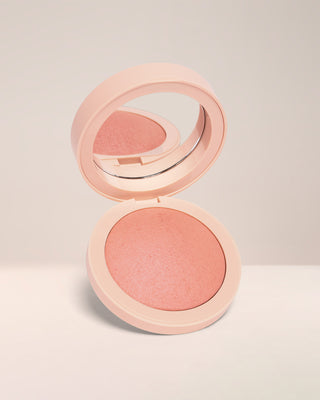 Open compact of EM Cosmetics Heaven's Glow Radiant Veil Blush in Magic Hour, showing the marbled, baked texture.